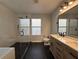 Bright bathroom featuring a glass shower, dual sink vanity with black hardware, and modern fixtures at 13124 Oulton Cir, Orlando, FL 32832