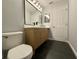 Stylish bathroom features wood cabinet vanity, black fixtures, and sleek tiled floor at 13124 Oulton Cir, Orlando, FL 32832