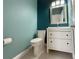 Stylish bathroom with white vanity and teal walls at 13124 Oulton Cir, Orlando, FL 32832