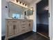 Bathroom featuring a dual-sink vanity with modern lighting and fixtures, with wood-look cabinetry at 13124 Oulton Cir, Orlando, FL 32832