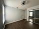 Bedroom with modern ceiling fan, gray walls, mirrored closet, and hardwood floors at 13124 Oulton Cir, Orlando, FL 32832