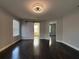 Bedroom featuring hardwood floors, neutral walls, barn door closet, modern ceiling fan and two windows at 13124 Oulton Cir, Orlando, FL 32832