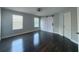 Bedroom featuring hardwood floors, neutral walls, barn door closet and two windows at 13124 Oulton Cir, Orlando, FL 32832