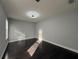 Neutral bedroom featuring modern lighting, gray walls, and dark wood flooring at 13124 Oulton Cir, Orlando, FL 32832