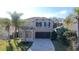 Two-story home featuring a neutral color scheme, well-manicured lawn, and a beautiful paver driveway at 13124 Oulton Cir, Orlando, FL 32832