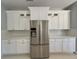 Spacious kitchen featuring white cabinets and a stainless steel refrigerator at 13124 Oulton Cir, Orlando, FL 32832