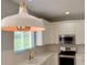 Bright kitchen with stainless steel appliances and pendant lighting at 13124 Oulton Cir, Orlando, FL 32832