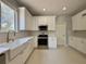 Well-lit kitchen featuring a farmhouse sink and stainless steel appliances at 13124 Oulton Cir, Orlando, FL 32832