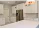 Elegant kitchen with stainless steel refrigerator and white cabinetry at 13124 Oulton Cir, Orlando, FL 32832