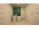 Bright laundry room with ample shelving, washer and dryer, and tile flooring at 13124 Oulton Cir, Orlando, FL 32832