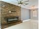 Comfortable living room featuring a modern fireplace, tile floors, and contemporary light fixtures at 13124 Oulton Cir, Orlando, FL 32832