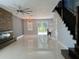 Open concept living room featuring modern lighting, glossy tile floors, and a stone fireplace accent wall at 13124 Oulton Cir, Orlando, FL 32832