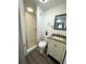 Modern bathroom with a walk-in shower, granite vanity, and wood-look flooring at 1338 S Elliott St, Sanford, FL 32771