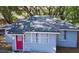 Cute gray house with red door, surrounded by large oak trees at 1338 S Elliott St, Sanford, FL 32771