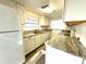 Kitchen with white cabinets, granite countertops, and white appliances at 1338 S Elliott St, Sanford, FL 32771