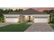 Two-car garage, light beige exterior, and a nicely landscaped front yard at 13563 Pearl Beach St, Winter Garden, FL 34787