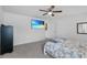 Bedroom with a ceiling fan, TV, and a bed at 139 Violet Ct, Kissimmee, FL 34759