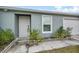 White front door with landscaping and white picket fence at 139 Violet Ct, Kissimmee, FL 34759