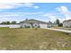 Landscaped front yard with a spacious lawn and a two-car garage at 139 Violet Ct, Kissimmee, FL 34759