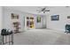 Bright living room featuring carpet flooring, sliding doors to patio, and neutral walls at 139 Violet Ct, Kissimmee, FL 34759