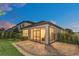 Screened patio and paved backyard space at dusk at 1401 Lone Feather Trl, Winter Park, FL 32792