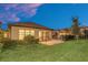 Evening view of backyard, screened patio, and nicely landscaped lawn at 1401 Lone Feather Trl, Winter Park, FL 32792