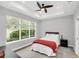 Cozy bedroom with a ceiling fan and large window at 1401 Lone Feather Trl, Winter Park, FL 32792