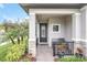 Inviting front porch with a stone walkway and black metal bench at 1401 Lone Feather Trl, Winter Park, FL 32792