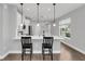 Kitchen island with seating and modern pendant lighting at 1401 Lone Feather Trl, Winter Park, FL 32792