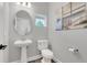 Clean powder room with pedestal sink and toilet at 1401 Lone Feather Trl, Winter Park, FL 32792