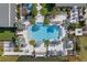 Aerial view of community pool with surrounding lounge chairs and landscaping at 1401 Lone Feather Trl, Winter Park, FL 32792
