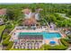 Aerial view of community pool, with surrounding buildings and landscape at 14531 Damai Ln, Orlando, FL 32821