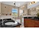 Bathroom with walk-in shower, granite vanity, and neutral tile at 14531 Damai Ln, Orlando, FL 32821