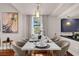 Modern dining room with white table and gold chairs, near kitchen at 14531 Damai Ln, Orlando, FL 32821