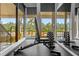 Weight bench with dumbbell set in a fitness center with pool view at 14531 Damai Ln, Orlando, FL 32821