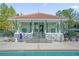 Community pool with adjacent clubhouse and seating area at 14531 Damai Ln, Orlando, FL 32821