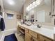 Well-lit bathroom with double vanity and a large mirror at 1511 Dunn Cove Dr, Apopka, FL 32703