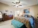 Primary bedroom with king bed, teal ottoman, and ensuite bathroom at 1511 Dunn Cove Dr, Apopka, FL 32703