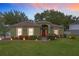 House exterior at dusk, showcasing landscaping and entryway at 1511 Dunn Cove Dr, Apopka, FL 32703