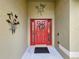 Red front door with decorative metal wall art at 1511 Dunn Cove Dr, Apopka, FL 32703