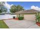 Attached garage with white door and landscaping at 1511 Dunn Cove Dr, Apopka, FL 32703