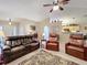 Spacious living room with leather furniture and views into the kitchen at 1511 Dunn Cove Dr, Apopka, FL 32703