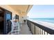 Oceanfront balcony with patio furniture and ceiling fan at 1513 Ocean Shore Blvd # 8F, Ormond Beach, FL 32176