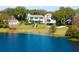 Aerial view of a waterfront home with lush landscaping at 1522 Lake Knowles Cir, Winter Park, FL 32789