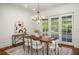 Bright dining room with wooden table and access to the backyard at 1522 Lake Knowles Cir, Winter Park, FL 32789