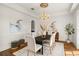 Bright dining room with hardwood floors, chandelier, and oval dining table at 1522 Lake Knowles Cir, Winter Park, FL 32789