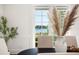 Dining room with water views and a large vase of pampas grass at 1522 Lake Knowles Cir, Winter Park, FL 32789