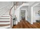 Elegant entryway showcasing a curved staircase and hardwood floors at 1522 Lake Knowles Cir, Winter Park, FL 32789