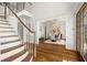 Grand entryway with hardwood floors, curved staircase and views to dining room at 1522 Lake Knowles Cir, Winter Park, FL 32789