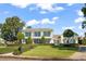 Two-story home exterior with manicured landscaping and brick driveway at 1522 Lake Knowles Cir, Winter Park, FL 32789